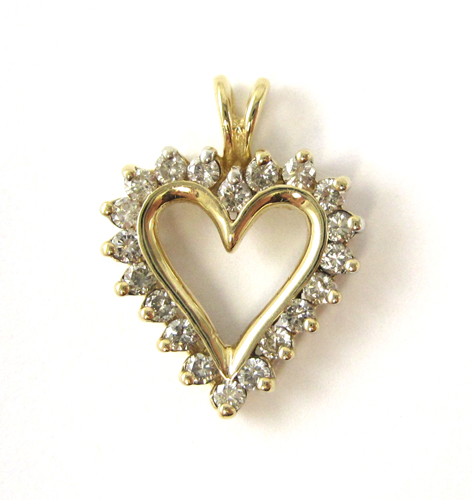 Appraisal: DIAMOND AND TEN KARAT GOLD PENDANT The open heart pendant