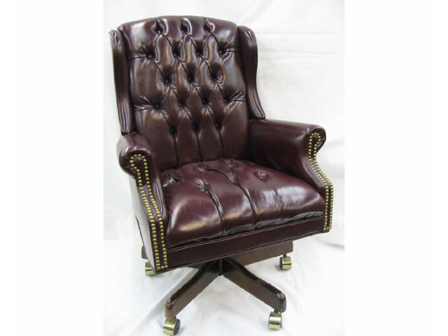 Appraisal: Executive style leather office chair with wine color buttoned upholstery