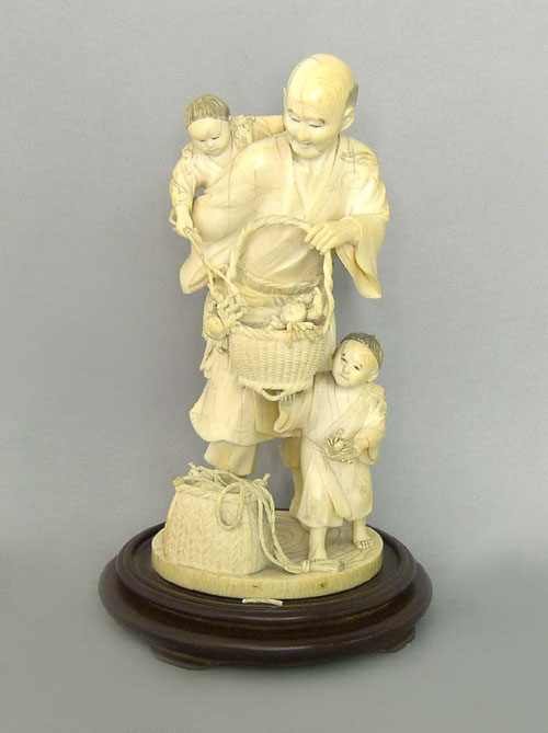 Appraisal: Carved Japanese ivory figure of a fisherman with caught fish