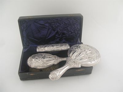 Appraisal: An Edwardian Art Nouveau dressing table set comprising clothes brush