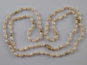 Appraisal: A freshwater cultured pearl necklace with a yellow metal tests