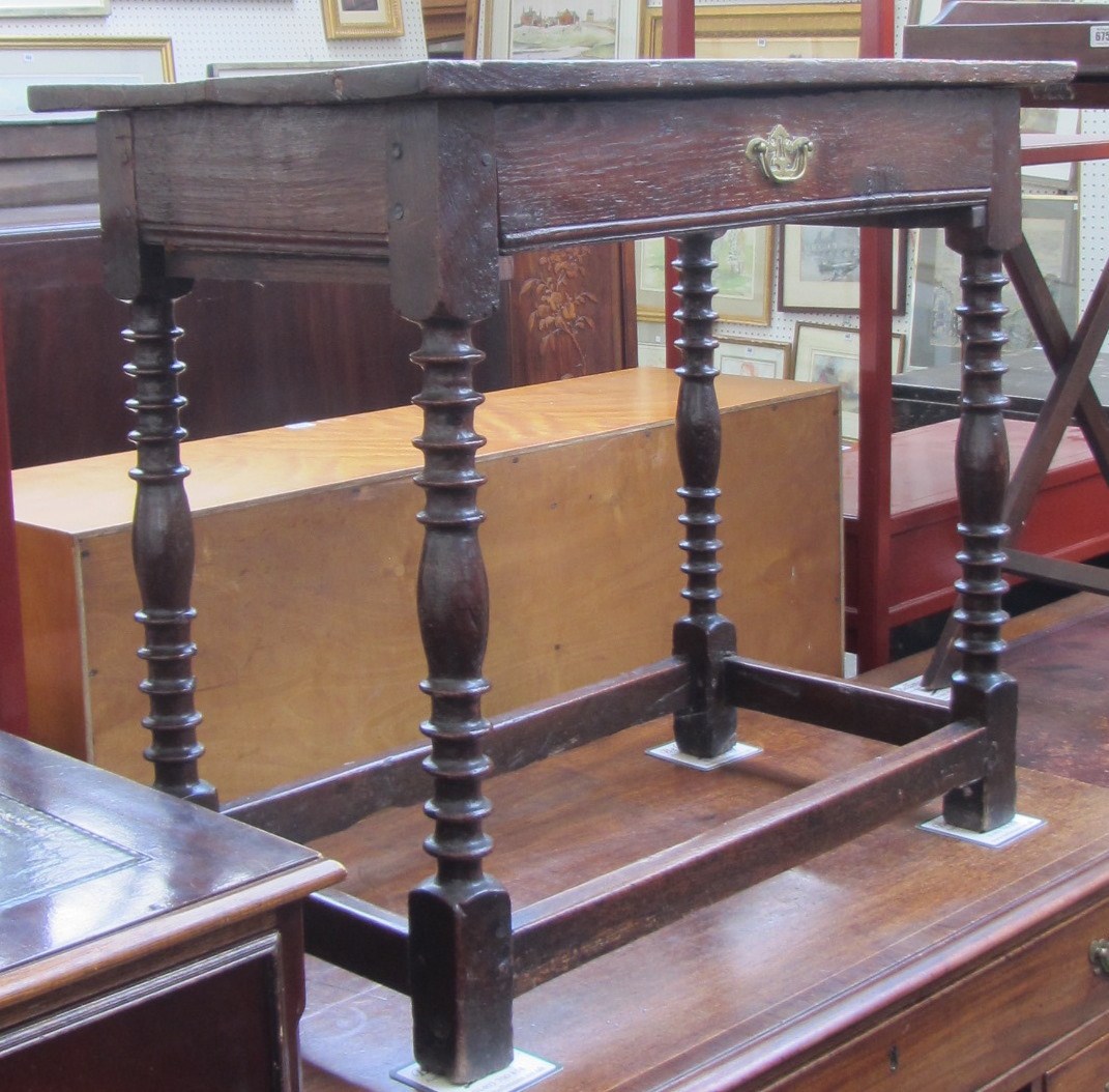 Appraisal: A th century oak side table the plank top over