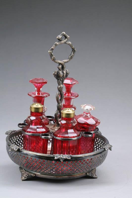 Appraisal: CASTOR SET Cranberry glass bottles in a silverplate holder with