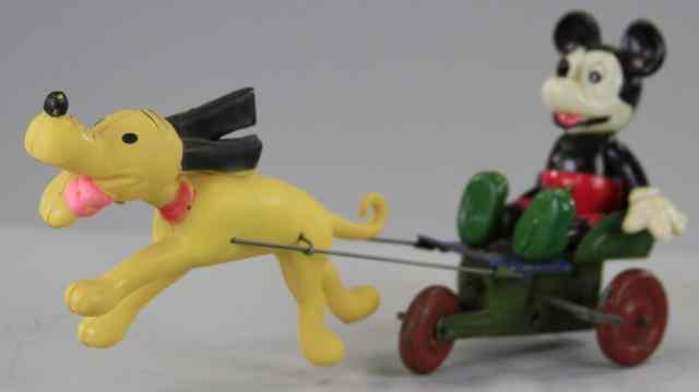 Appraisal: MICKEY PULLED BY PLUTO Japan celluloid figure depicts Mickey pulled