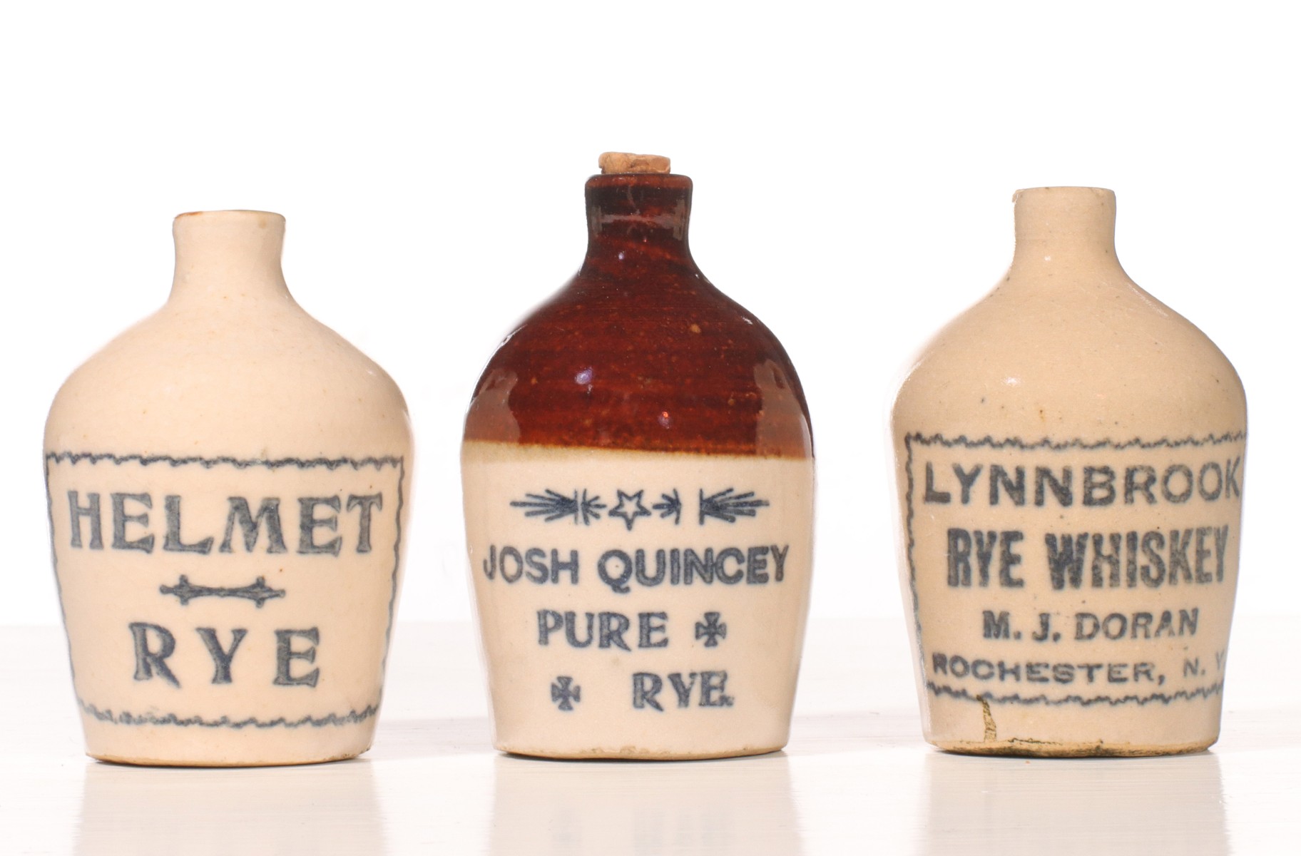 Appraisal: THREE RYE WHISKEY STONEWARE MINI JUGSThe condition is as shown