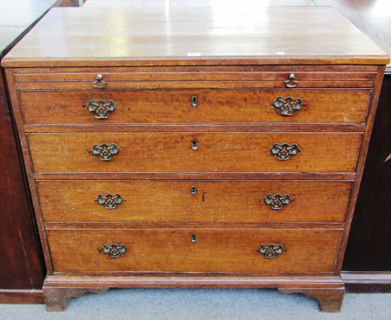 Appraisal: A George III mahogany four drawer chest with brushing slide