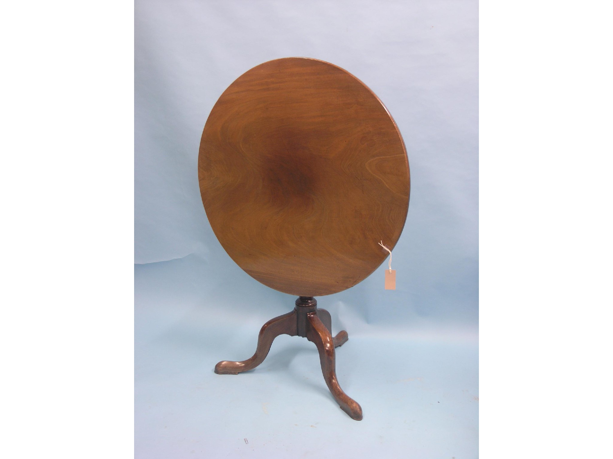 Appraisal: A George III mahogany tilt-top tripod table circular top on