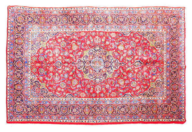 Appraisal: A KASHAN RED GROUND SMALL CARPET with all over scrolling