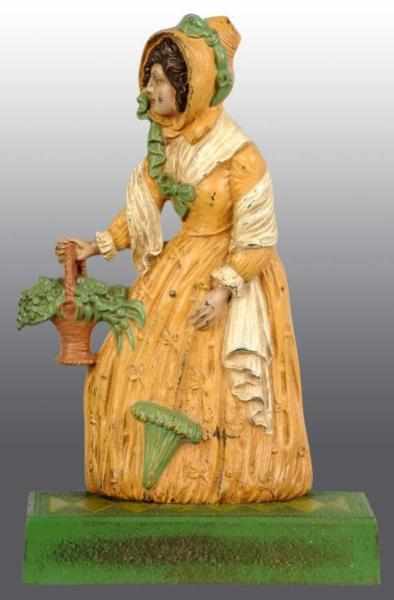 Appraisal: Cast Iron Lady with Basket Parasol Doorstop Description Marked B