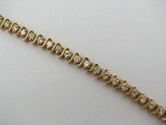 Appraisal: K yellow gold ''S'' design tennis bracelet with diamonds approximately