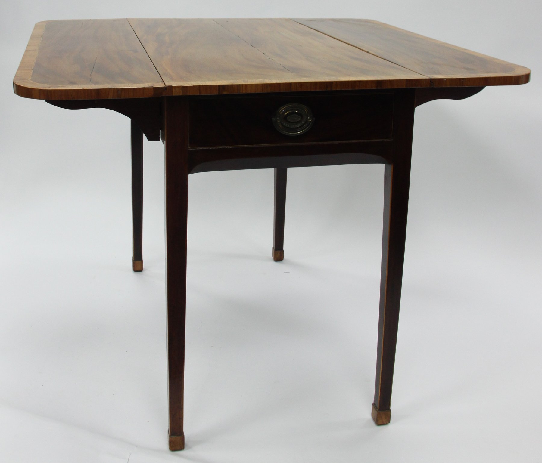 Appraisal: A mahogany two-flap Pembroke table crossbanded on square taper legs