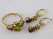 Appraisal: A carat gold smokey quartz and peridot ring with matching