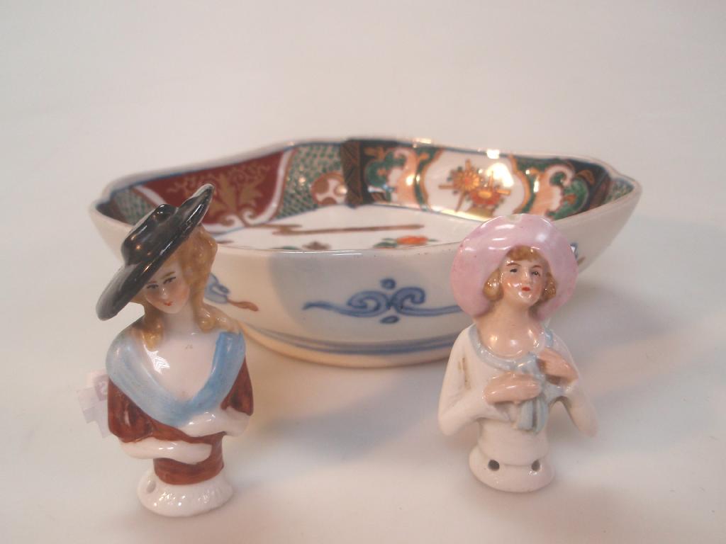 Appraisal: A small Japanese lozenge dish and two porcelain half dolls