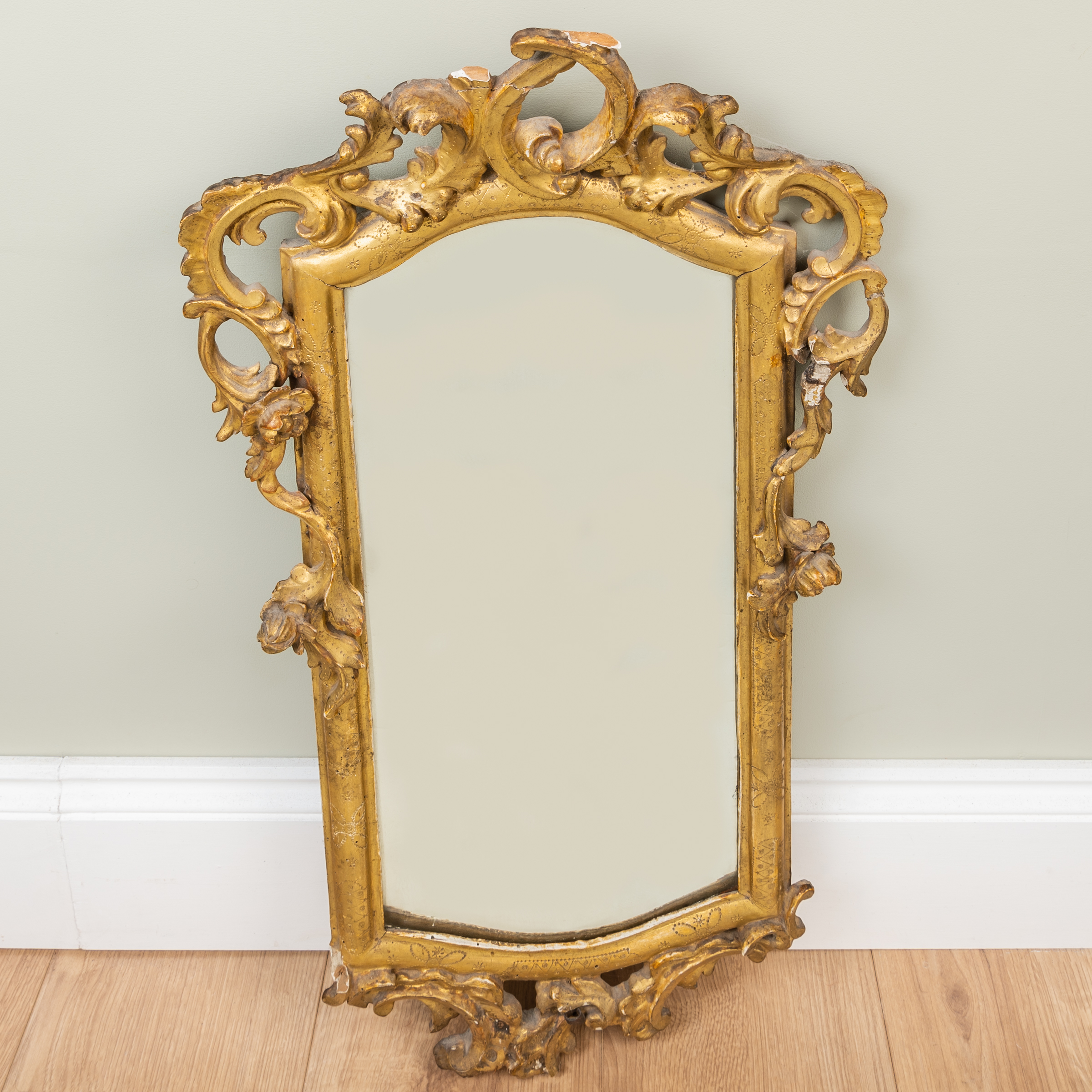 Appraisal: An antique Venetian gilt carved wooden gesso moulded wall mirror