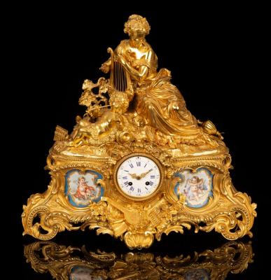 Appraisal: A gilt metal and porcelain mounted mantel clock the white