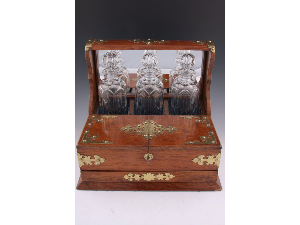 Appraisal: Tantalus-Style Oak Liquor Cabinet contains three cut and pressed glass