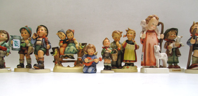 Appraisal: FOURTEEN GERMAN HUMMEL FIGURINES of soft paste porcelain TM- -