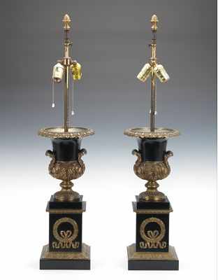 Appraisal: A Pair of Urn Shape Lamp Bases Ornate metal urns