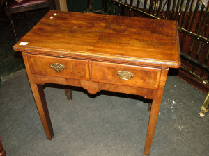 Appraisal: A walnut side table th century the rounded top above