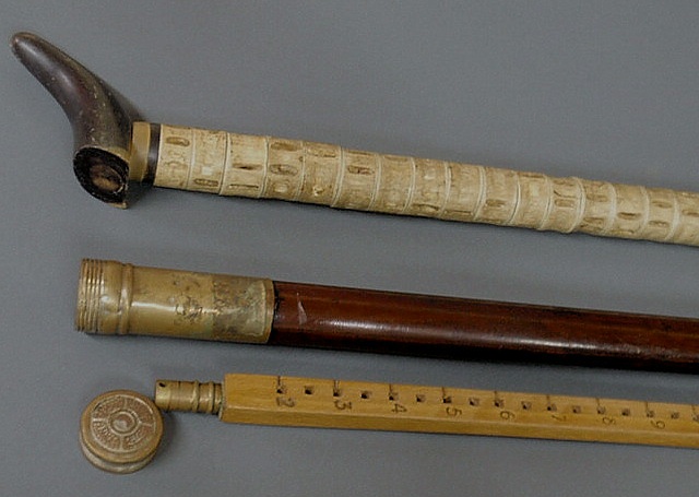 Appraisal: Two walking sticks- a bone vertebrae example and a brass