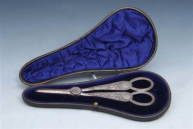 Appraisal: AN EDWARDIAN PAIR OF SILVER GRAPE SCISSORS with cast handles