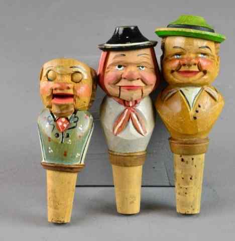 Appraisal: GERMAN CARVED WOODEN STOPPERSDepicting German gentlemen having cork-covered bottle stopper