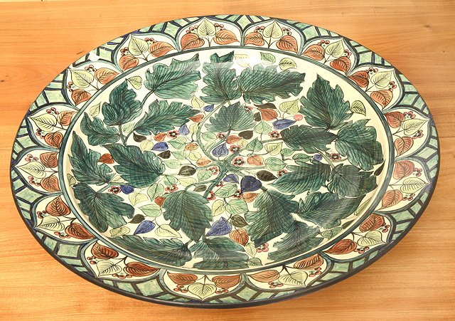 Appraisal: A LARGE WEDGWOOD TIN GLAZED CHARGER decorated with flowering foliage