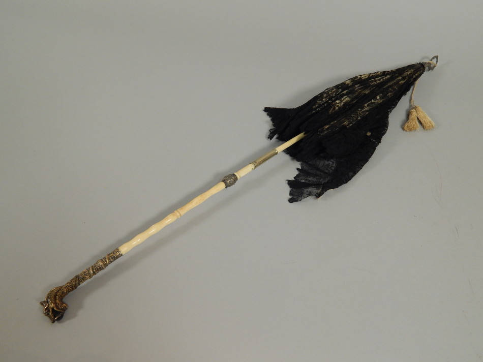 Appraisal: A late thC ivory and gilt metal parasol with a