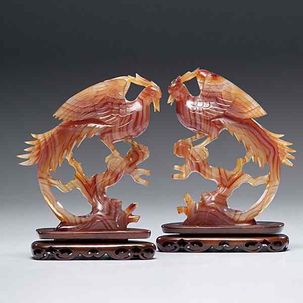 Appraisal: Chinese Carnelian Phoenix Chinese a pair of carved semi-translucent carnelian