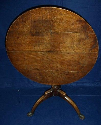 Appraisal: A George III oak tripod table the circular top on