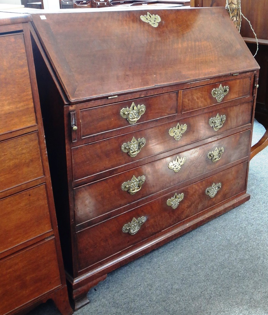 Appraisal: A mid th century mahogany bureau the fall enclosing a