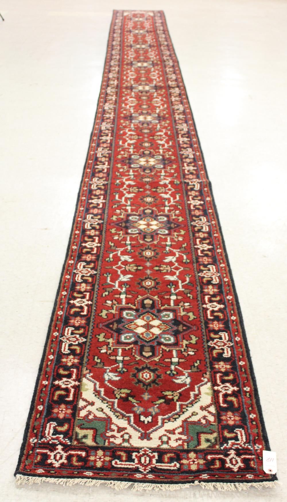 Appraisal: HAND KNOTTED ORIENTAL LONG RUG Indo-Persian stylized floral and repeating