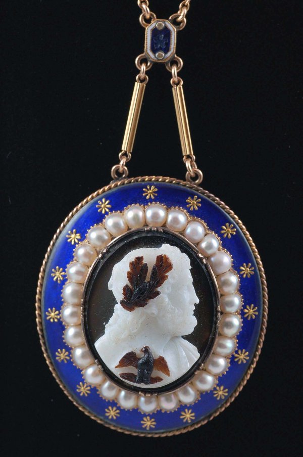 Appraisal: Finely carved hardstone cameo set in blue enameled frame with