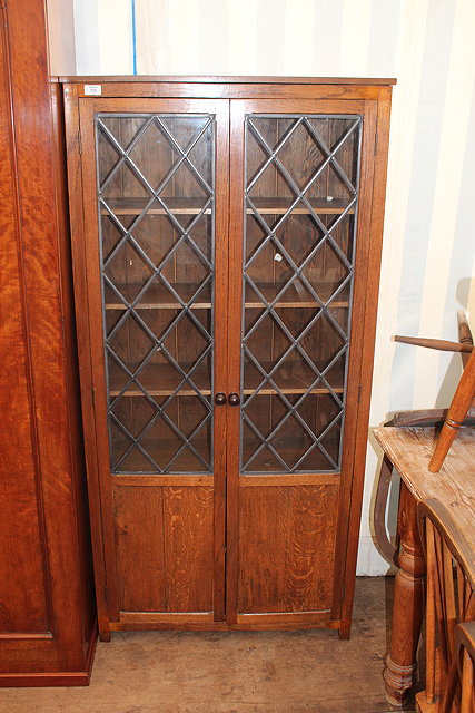 Appraisal: A MID TH CENTURY OAK GLAZED BOOKCASE CABINET doors opening