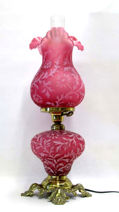 Appraisal: PINK SPANISH LACE GLASS HURRICANE LAMP having brass four-foot base