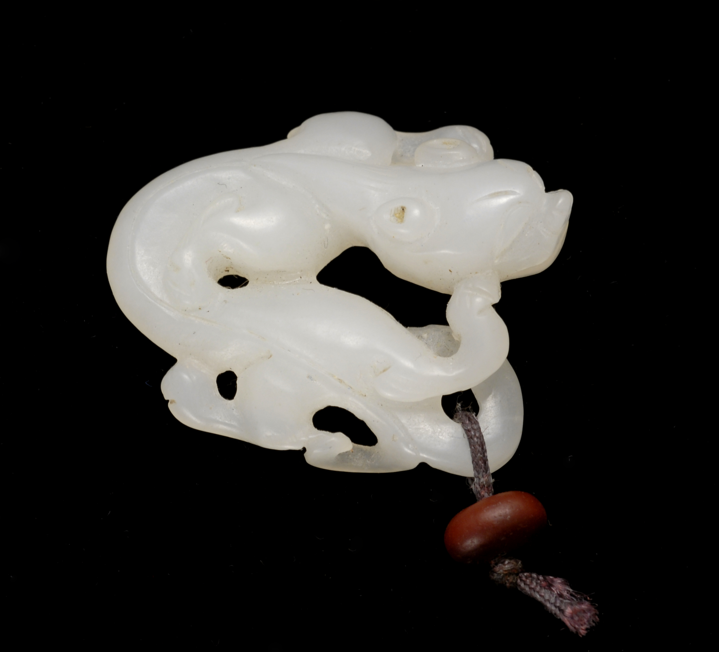 Appraisal: WHITE JADE PENDANT In the form of a coiled dragon