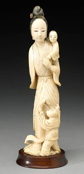 Appraisal: An ivory carving of a female figure with two children