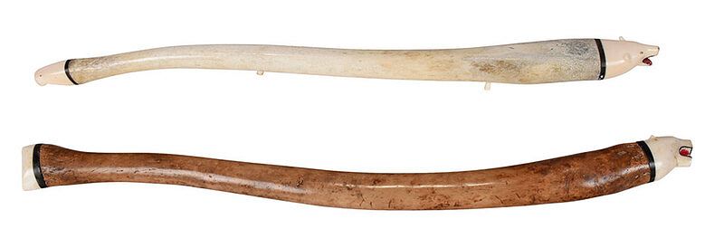 Appraisal: Two Inuit Carved Walrus Baculum Oosiks mid th century fossilized