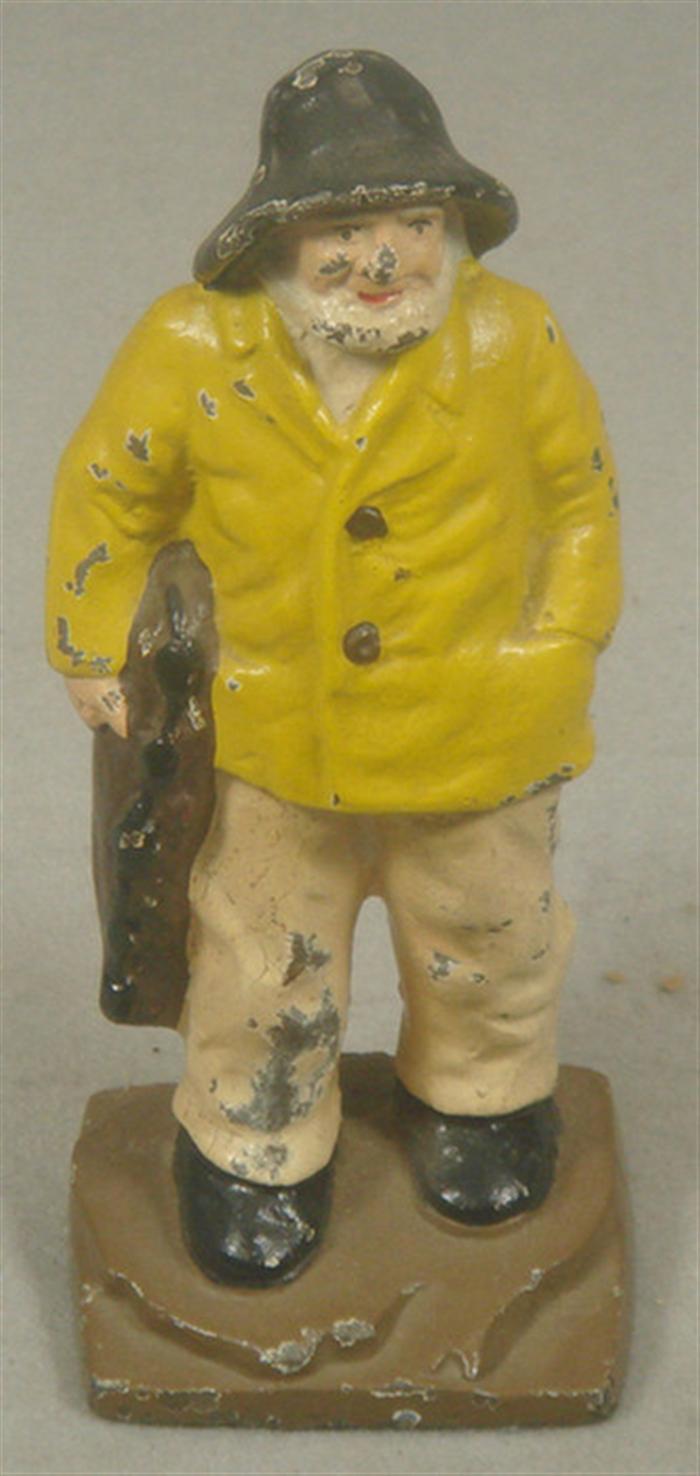 Appraisal: Cast iron doorstop old seaman in yellow rain slicker with