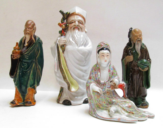 Appraisal: FOUR CHINESE QING EARTHENWARE FIGURES consisting of two standing mud