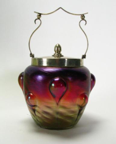 Appraisal: Iridescent magenta and amber art glass biscuit jar with electroplate