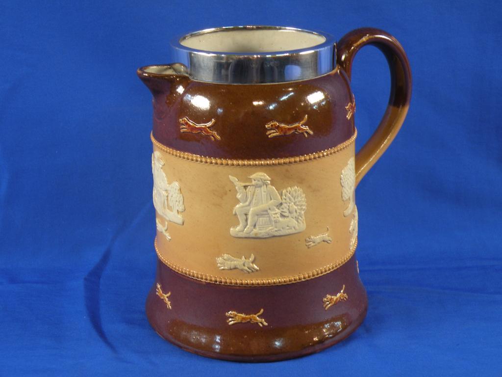 Appraisal: A Royal Doulton stoneware hot water jug decorated in relief