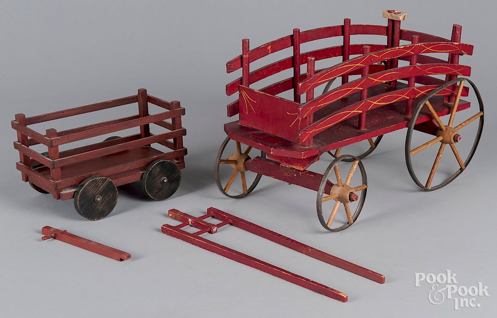 Appraisal: Two painted wood wagons Two painted wood wagons one is