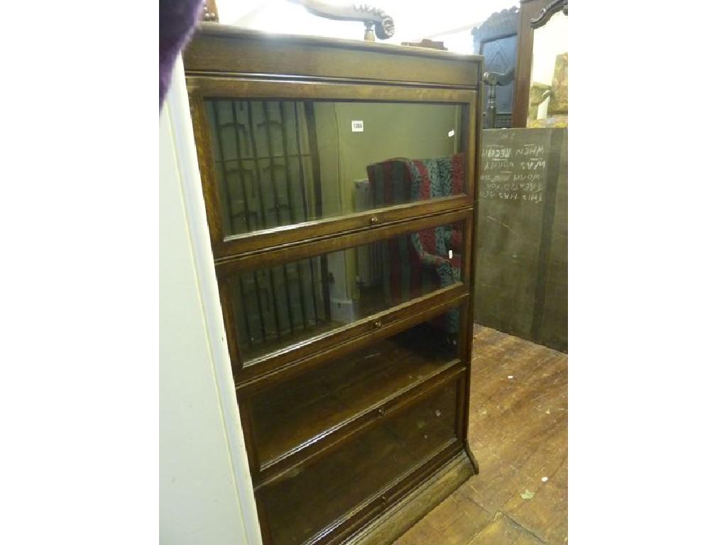 Appraisal: A Globe Wernicke style oak framed four sectional freestanding library