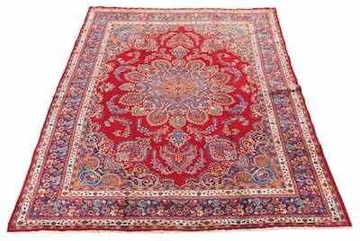 Appraisal: A Large Mashad Carpet Cranberry red ground with curvy medallion