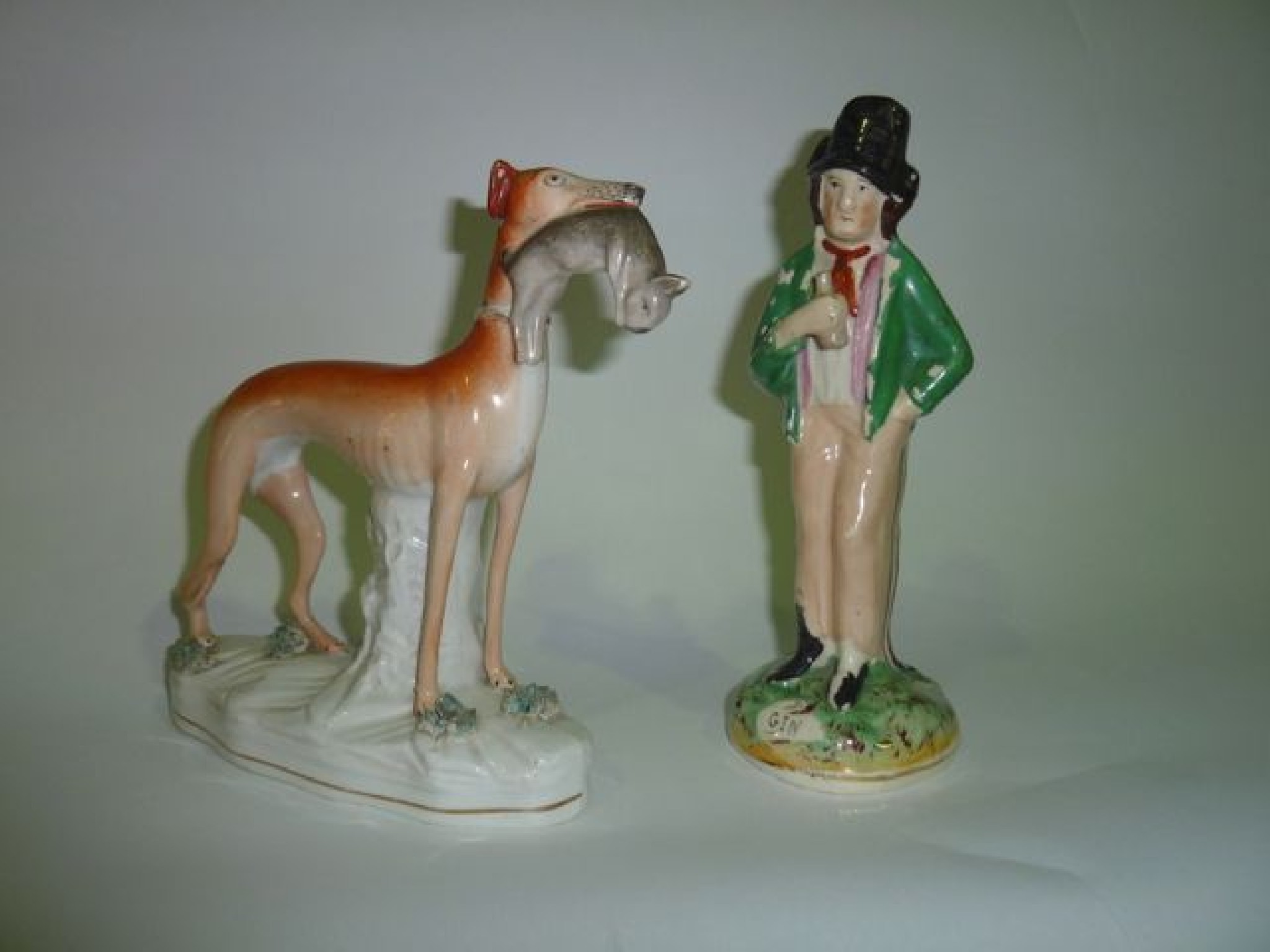 Appraisal: A th century Staffordshire figure of a greyhound with rabbit