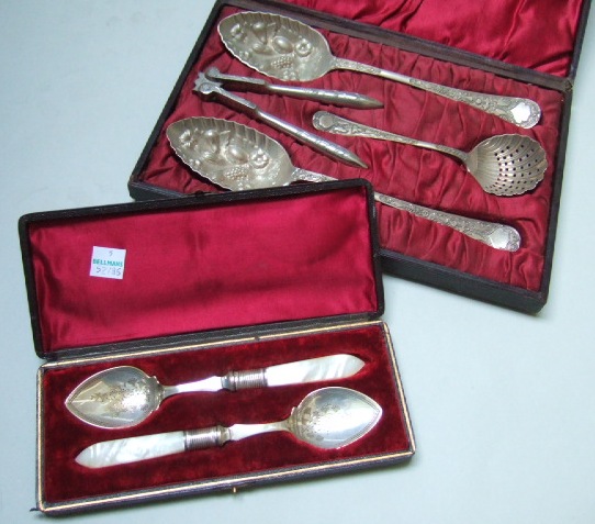 Appraisal: A plated dessert set comprising a pair of fruit spoons