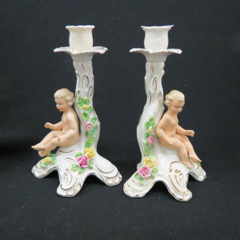 Appraisal: Pair of Dresden Porcelain Figural Candlestickswith naked child and floral