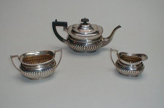 Appraisal: A George V silver three-piece tea service of rounded rectangular