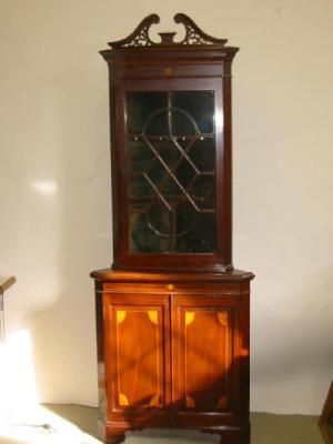 Appraisal: A MAHOGANY STANDING CORNER CUPBOARD with stringing and marquetry roundels